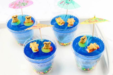 Since we are on a roll with cute mini desserts, let's sneak in a fun summer dessert that the kids will absolutely adore..Beach Days Jello Cups Recipe. Bible School Snacks, Shark Week Ideas, Beach Dessert, Gummy Fish, Jello Cups, Blue Jello, Jello Dessert, Jell O Shots, Jello Desserts