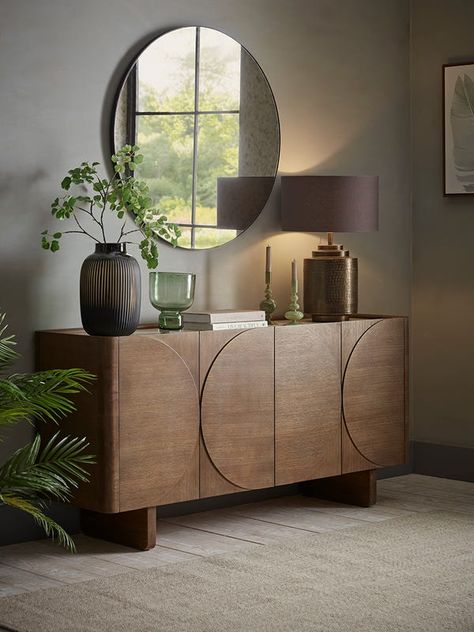 Crafted from a dark wood, our Tena sideboard is subtly brightened with a light marble effect top, creating a beautiful contrast to the moodier wood. Four doors with semi circles on each door conceal two cupboards with one shelf in the centre, perfect for keeping your home looking tidy and clutter free. Dress this sideboard with accessories from our Industrial trend for a modern and sleek finish. Top Of Sideboard Decor, Side Board Decor Ideas Dining Rooms, Side Board Decor Ideas, Sideboard Decor Dining Room, Sideboard Living Room, Marble Sideboard, Sideboard Tv Stand, Sideboard Styling, Dark Wood Sideboard