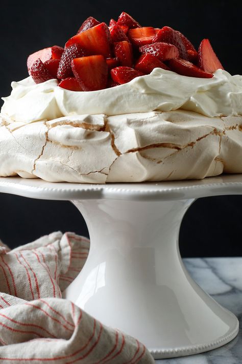 The particular joy of this dreamy dessert, which was named in honor of the Russian ballerina, is that the meringue base can be made in advance Then to serve it, drizzle the strawberries with a little balsamic vinegar and vanilla (a combination that brings out the fullest essential flavor of the fruit), whip some cream and arrange it all on a plate It’s magnificent, and deliriously easy. Nigella Pavlova Recipe, Joy Of Cooking Recipes, Fruit Whip, Strawberry Pavlova, Pavlova Recipe, Strawberry Season, Nyt Cooking, Nigella Lawson, Paula Deen