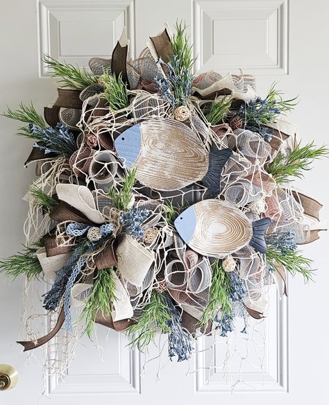 🌊🐟 Dive into coastal charm with our Nautical Wreath! 🐟🌊 Bring the serene beauty of the sea to your door with this stunning nautical-themed wreath. Featuring rustic wooden fish, natural elements, and a mix of earthy and ocean hues, it's perfect for adding a touch of seaside elegance to your home. Order yours now from our Etsy shop: www.etsy.com/shop/ILoveYourWreath Follow us for more unique creations: www.facebook.com/ILoveYourWreaths Coastal Christmas Wreath, Coastal Door, Beach Wreaths, Rustic Stools, Ocean Hues, Nautical Wreath, Seaside Theme, Themed Rooms, Beach Wreath