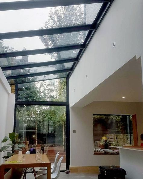 An internal view of the lean-too aluminium glass roof connected using structural silicone for a minimal sightline, below our new #pivotdoor… Extension With Glass Roof, Double Height Glass Extension, Kitchen Extension Terraced House, Clear Veranda Roof, Glass Joining Extension, Small Glass Box Extension, Glass Roof Extension, Aluminium French Doors, Lean To Roof