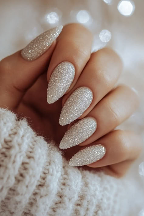 15 Chic Neutral Holiday Nails You’ll Adore Textured Glitter Nails, Deep Blue Sparkle Nails, New Year Glitter Nails, Fair Isle Nails, Holiday Party Nails Sparkle, Christmas Vibe Nails, New Years Eve Nail Ideas, Neutral Christmas Nails Acrylic, New Year’s Eve Nails Almond