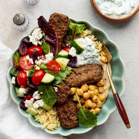 Along with kebabs, orzo, hummus, a simple Greek salad, and homemade tzatziki, this all-in-one bowl meal featuring Trader Joe's Greek chickpeas is one the whole family loves. Orzo Bowl, Simple Greek Salad, Mediterranean Bowls, Greek Vinaigrette, Greek Chickpeas, Mediterranean Chickpea Salad, Homemade Tzatziki, Dinner This Week, Tzatziki Sauce