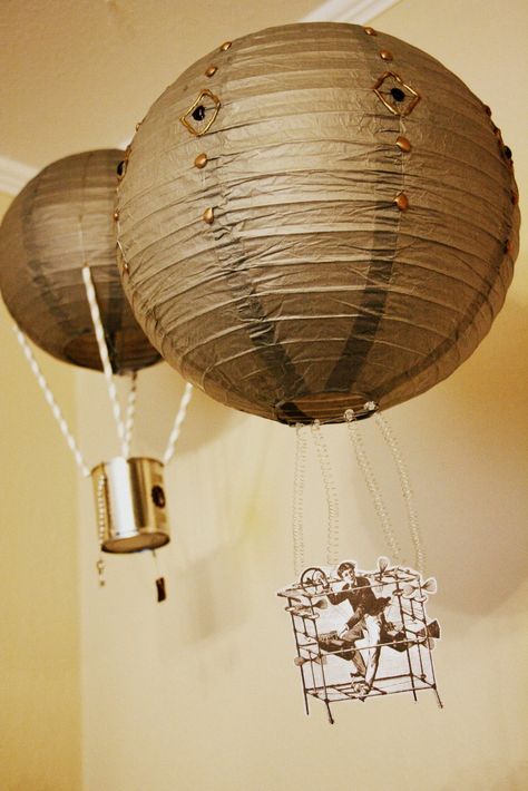 Quick Steampunk Hot air Balloons. (paper lanterns, hot glue, metallic sharpies, coiled floral wire, paper printout -or- alluminum can, beads, lock and key charms, floral wire and straws ) Steampunk House Decor, Steampunk Classroom Decor, Steampunk Classroom, Steampunk Party Decorations, Steampunk Birthday, Steampunk Bedroom, Carnival Parties, Steampunk Party, Steampunk Theme