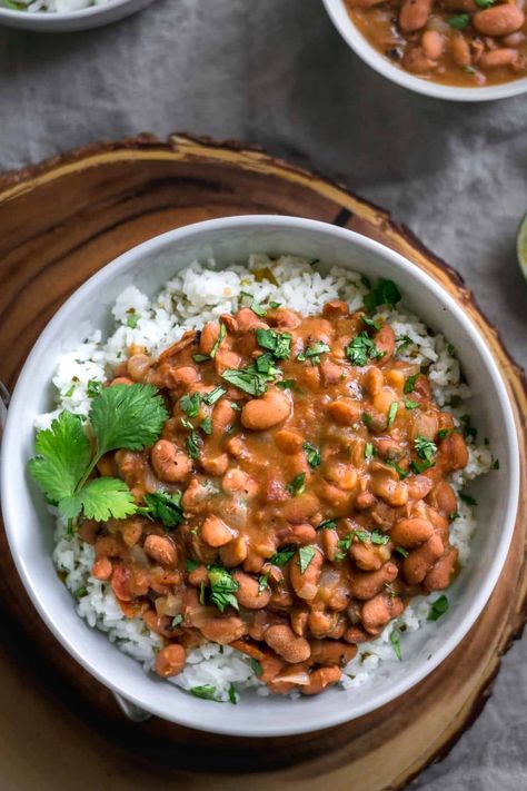 Pinto beans are cooked in the oven until tender and soft, then finished on the stovetop for flavorful, restaurant style, creamy beans. The rice is flavored with tomatillos, cilantro, and lime for the perfect tangy accompaniment. Protein Entrees, April Recipes, Pinto Beans And Rice, Creamy Beans, Mexican Pinto Beans, Cilantro Lime Rice Recipe, Meatless Dinners, Lime Rice Recipes, Pinto Bean Recipes