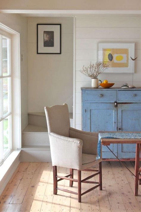 A Cottage Reborn in Coastal Maine - Remodelista Yellow Buffet, Kitchen Armchair, Scandi Cottage, Hidden Stairs, Blue Cupboards, Distressed Furniture Diy, Blue Cabinet, Interior Studio, Blue Dresser