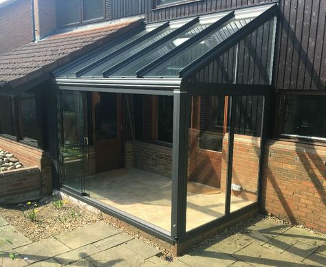 This glass room creates a covered space to access the house.        This addition of this glass room to this property offers protection from the elements.    The area created allows the owners and visitor alike to take off wet clothing or muddy boots under cover, helping to keep the house clean.    When the internal doors are left open, they also Extension Veranda, Lean To Conservatory, Modern Conservatory, Conservatory Ideas, Glass Porch, Glass Conservatory, Conservatory Design, Garden Room Extensions, Glass Cabin