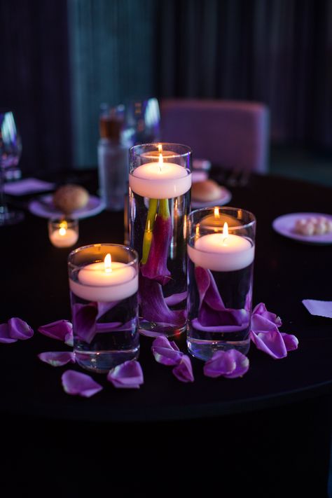 Submerged purple calla lilies with floating candles and rose petals. #studioag #studioagdesign #wchicagolakeshore #chicagoweddings Photo by: rachel g photography https://www.facebook.com/rachelgphotography Purple Candle Centerpieces, Floating Candles In Water, Candles In Water, Candles And Rose Petals, Purple Table Decorations, Wedding Table Deco, Purple Wedding Tables, Purple Wedding Centerpieces, Purple Centerpieces