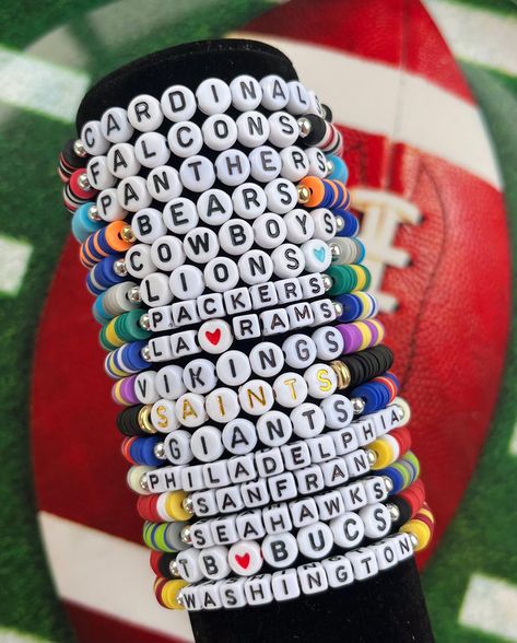 Handmade Bracelet-Ships from Upstate New York!  🏈Support your favorite NFL team with this personalized bracelet! 🏈This listing is for ONE bracelet, which includes clay beads matching your team's colors, white cubes with black letters, and one silver bead. Personalize it with any word or name you would like. 🏈For stack of 3 bracelets, please order through this link: https://www.etsy.com/listing/1745570066/kansas-city-chiefs-stack-bracelet-chiefs 🏈To order an all silver or all gold beaded bracelet to stack, please order through this link: https://www.etsy.com/listing/1749519192/goldsilver-bead-bracelet-gold-bead 🏈Standard letter beads are white with black lettering, either round or cube. Other letter options may be available such as white with gold or colored; feel free to inquire when Football Team Bracelets, Football Clay Bead Bracelets, Messi Bracelet, Braclets Diy, Fan Bracelet, Team Bracelets, Football Bracelet, Gold Beaded Bracelet, Stack Bracelet