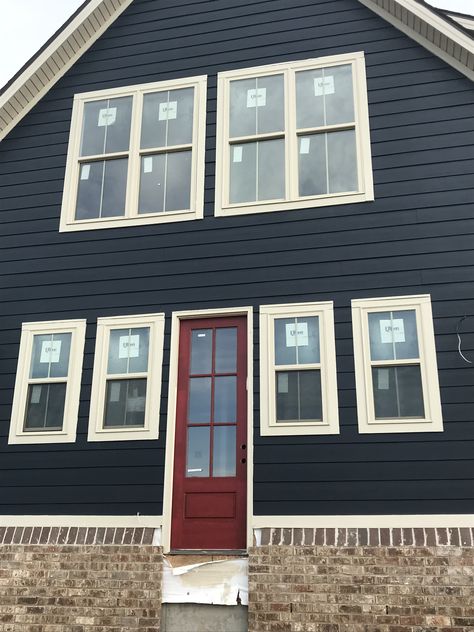 Brigand navy paint and CrabbyApple Sherwin Williams red door Navy House Red Door, Blue Gray Exterior House Colors Red Door, Blue Siding Red Door, Red Door Blue House, Dark Blue House Red Door, Navy Blue House With Red Door, Blue House Red Trim, Black House Red Door, Navy House Door Color