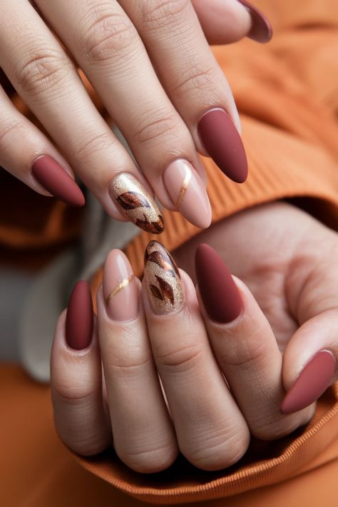 Embrace the cozy vibes of autumn with these stunning almond nails, a perfect blend of elegance and trend. Think deep burgundy and warm taupe shades, intricately adorned with delicate gold foils that mimic falling leaves. These fall nail ideas will elevate your seasonal style, ensuring your manicure stands out. Ready to make a statement this fall? Dive into these chic designs and let your nails shine! #FallNailIdeas #NailArt #AlmondNails #AutumnNails Oval Nails Autumn, Fall Nail Ideas, Warm Taupe, Chic Autumn, Autumn Look, Falling Leaves, Deep Burgundy, Fall Nail, Cozy Vibes