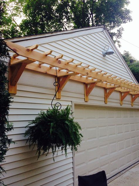 Garage door trellis or arbor project. Made with cedar decking and 4x4s and ripped 2x4s...  A little added curb appeal? Cedar Arbor Over Garage Door, Above Garage Trellis, Window Pergola With Shutters, Trellis Over Garage Door, Trellis Over Garage, Garage Door Trellis, Garage Arbor, Ladder Craft, Front Foor