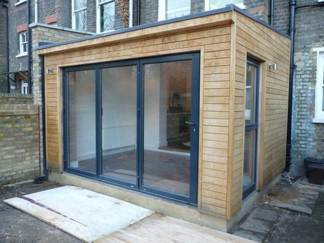 The wooden cladding, bifold doors and skylights = exactly what we want at the back of our house, but at least twice the width and depth with a kitchen to one side. Wooden Cladding Extension, Wooden House Extension, Cladded Extension, Wooden Extension Ideas, Wooden Extension, Wood Extension, Small House Extensions, Bungalow Extensions, Flat Roof Extension