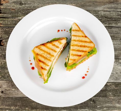 Sliced sandwich on white plate, top view... | Premium Photo Plating Sandwich, Sandwich Plating Ideas, Food Top View, Paneer Sandwich, Big Sandwich, Food Photography Lighting, Plate Of Food, Ice Cream Menu, Food Illustration Design