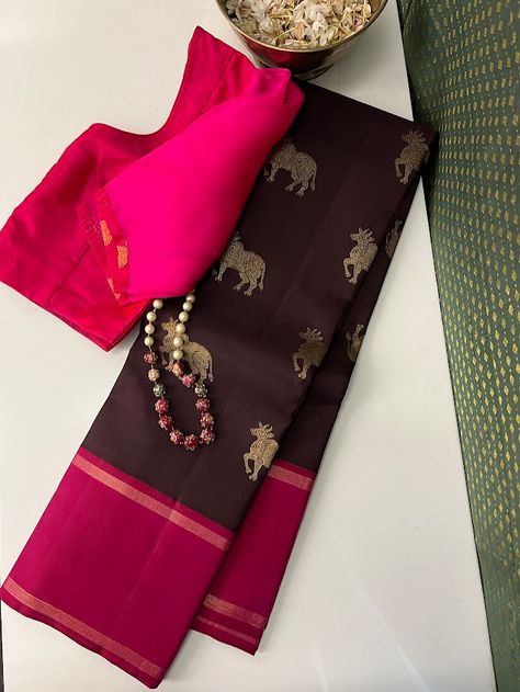 Pure kanchipuram silk saree woven in the korvai style , this saree is a signature Aavaranaa creation. The body has the kamdhenu motifs woven in pure zari, the border is kept simple but the pallu is richly woven in a traditional pattern with mythological figures and other smaller patterns like rudrakshams. This is a dark chocolate brown with pink border. The blouse piece is plain border colour Wine Colour Pattu Saree, Pearl Blouse Designs, Brown Kanchipuram Silk Saree, Trendy Silk Sarees, Pearl Blouse, Kalamkari Fabric, Kanchi Sarees, Kanjeevaram Sarees, Kanjivaram Sarees Silk