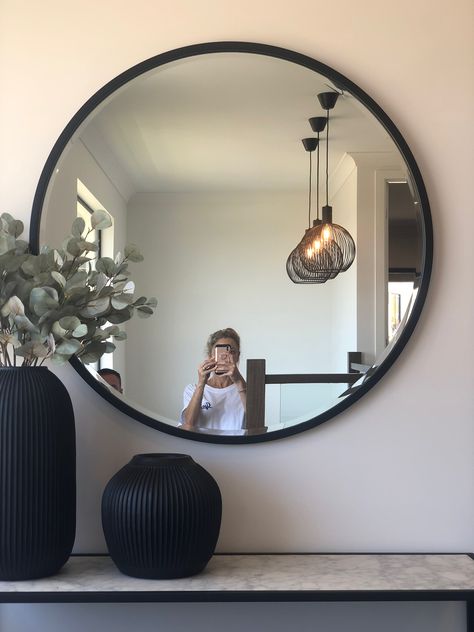 Off Center Round Mirror, Bottom Of Stairs Mirror, Mirror At Top Of Stairs, Accent Cabinet Decor, Round Mirror Decor Ideas, Staircase Landing Ideas, Void Lighting, Black Circle Mirror, Mirror Stairs