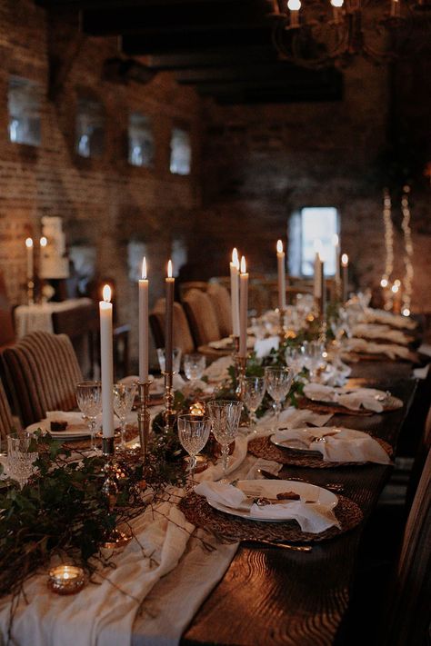 White table runner with foliage, wicker placemat, white and grey candles and crystal glassware for a cosy rustic winter wedding Cottagecore Winter Wedding, January Wedding Aesthetic, Rustic Winter Wedding Table Decor, Winter Wedding Uk, Vintage Winter Wedding Aesthetic, Winter Micro Wedding, Rustic Winter Party, Winter Wedding Table Settings, Winter Wedding Tablescapes