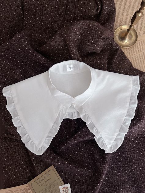 I'm glad to introduce you: Grette - the Peter Pan detachable collar with ruffles and pearl button on the front. The size depends on the circumference of the neck: S-34-35cm M-36-37cm L-37-38cm The collar wide including ruffles is 15cm care recommendation: Hand wash in warm water and dry flat. Low temperature iron. If you have any questions please don't hesitate to contact me. The item is ready to ship in 1-3 days after payment. Handmade with love in the USA. worldwide shipping. Compostable package🌱 Stylish Business Outfits, Outfit Inso, Bib Collar, Neck Accessories, Detachable Collar, Fashion Project, Designs For Dresses, Historical Costume, Pan Collar