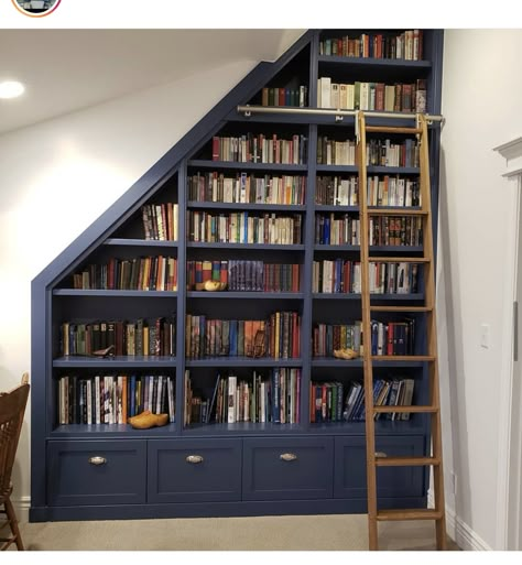 Home Library Slanted Ceiling, Slanted Wall Library, Sloping Roof Bookshelf, Sloped Ceiling Library, Library Sloped Ceiling, Understairs Library Ideas, Bookshelf On Slanted Wall, Built In Bookcase Under Stairs, Bookcase On Angled Wall