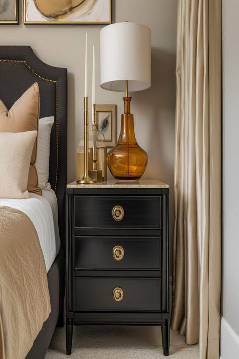 Sophisticated bedroom showing a black nightstand with golden lamp and decor, complementing the neutral-toned bedding. White And Golden Bedroom Ideas, Traditional Bedroom Inspirations, Black Furniture Decor Ideas, Bedroom With Different Nightstands, Black Bed Nightstand Ideas, Bedroom Black Furniture Decor, Black Lacquer Furniture, How To Style Black Bedroom Furniture, Black Night Stands Bedroom