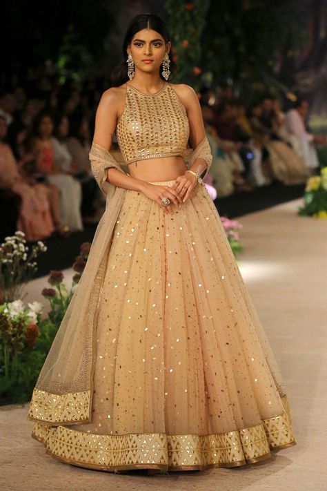 Embroidered lehenga with halter neck blouse Gold Blouse For Lehenga, Gold Lehenga Designs, Golden Blouse Designs Lehenga Choli, Gold Lehenga Blouse, Golden Lehenga Bridesmaid, Gold Lehenga Simple, Gold Lehenga Skirt, Gold Indian Outfit, Shadi Ideas