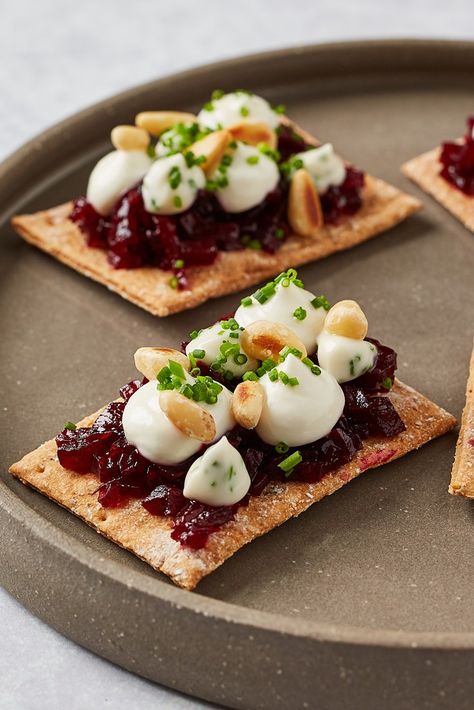 These stunning canapés from Paul Welburn would make the perfect start to a vegetarian dinner party. Spelt and fig crispbreads are topped with juniper-spiced beetroot jam, whipped goat's cheese, a creamy chive mayonnaise and toasted pine nuts. All the elements can be made in advance, making this a simple assembly job on the day you plan to serve them. Goats Cheese Canapes, Vegetarian Canapes Ideas, Beetroot Canapes, Beetroot Appetizer, Festive Canapes, Beetroot And Goats Cheese, Canapes Ideas, Vegetarian Canapes, Vegetarian Dinner Party