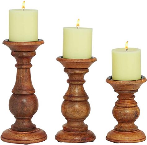 TRADITIONAL STYLE: Large, textured white candlesticks with spiked candle plates NATURAL MANGO WOOD: 100% mango wood candle holders, made in India TEXTURAL TURNED WOOD: Elegant silhouette from the turned wood base inspired by antique wood furniture with a textural heavily whitewashed finish with light natural brown mango wood peeking through some parts; solid black candle plate features a spike to secure your pillar candle in place (candle not included) Set of 3 white candle holders made from nat Wood Votive Candle Holder, Brown Candle Holders, Pillar Candle Stand, Wood Pillar Candle Holders, Traditional Candle, Pillar Candle Holder, Rustic Candle Holders, Wooden Candle Sticks, Mango Tree