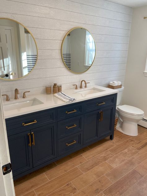 Navy Double Sink Bathroom Vanity, Navy Blue Bathroom Floor Tile Ideas, Shiplap Over Bathroom Vanity, Blue Vanity Bathroom Farmhouse, Bathroom Floor Tile Ideas With Blue Vanity, Blue Vanity White Tile Bathroom, Bathroom With Wood Look Tile Floor, Navy Bathroom Vanity Gold Hardware, Shiplap Bathroom With Gold Fixtures