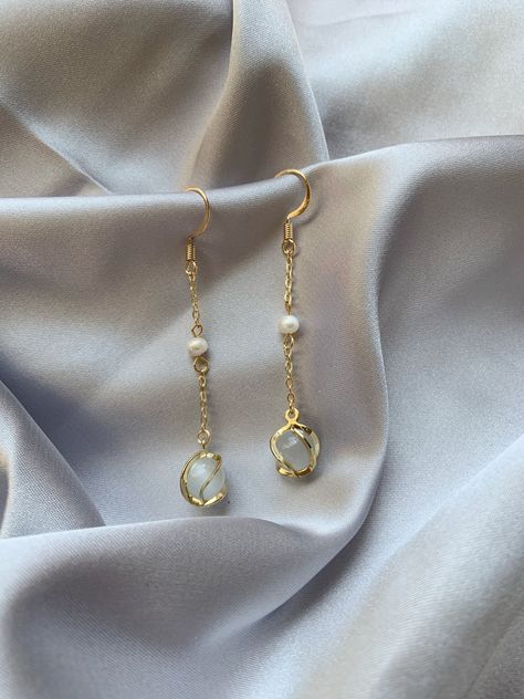 💖 ITEM INFORMATION 💖  *14K gold plated hook and chain connecting a white pearl and opal stone. The wire twist/spiral on the surface of the stone adds another layer to the design. *Length: 4.7 cm ✈️ SHIPPING INFORMATION ✈️  *All products are made in British Columbia, Canada, where I will ship the earrings. The processing time before dispatch takes 1-2 business days. The following shipping timeframe only represents an estimate, and please keep it in mind when you place an order.  ALL ORDERS ARE Opal Earrings Dangle, Chain Earrings Gold, Opal Drop Earrings, Threader Earrings Gold, Earrings Opal, Earrings Chain, Drop Earrings Gold, Opal Earrings Stud, Pink Jewelry