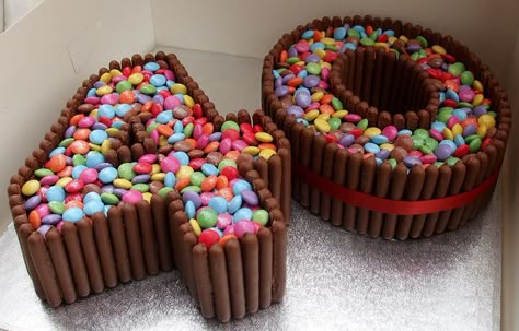 Cool 40 birthday cake with cadburys fingers and smarties Kitkat Cake, Number Birthday Cakes, Shaped Cakes, 40th Cake, 40th Birthday Cakes, Number Cakes, 40th Birthday Parties, Diy Cake, Creative Cakes