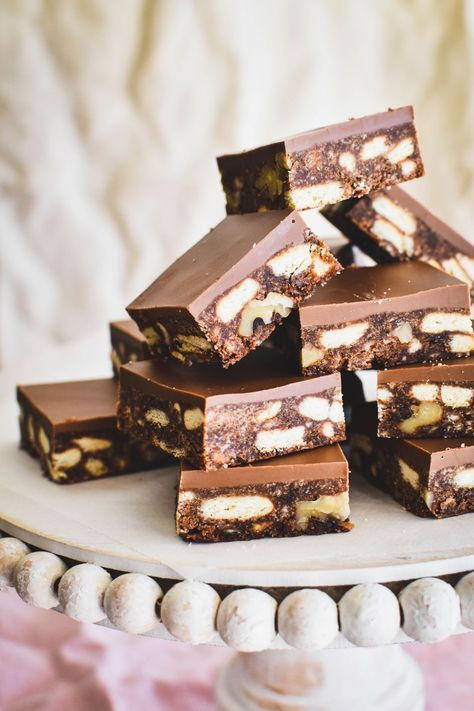 hedgehog slice squares piled up on cake stand. Hedgehog Slice Recipe, Slice Of Chocolate Cake, Hedgehog Slice, Chocolate Hedgehog Slice, No Bake Crunchie Slice, Coconut Ice Recipe, Peppermint Slice, Hedgehog Cake, Coconut Slice