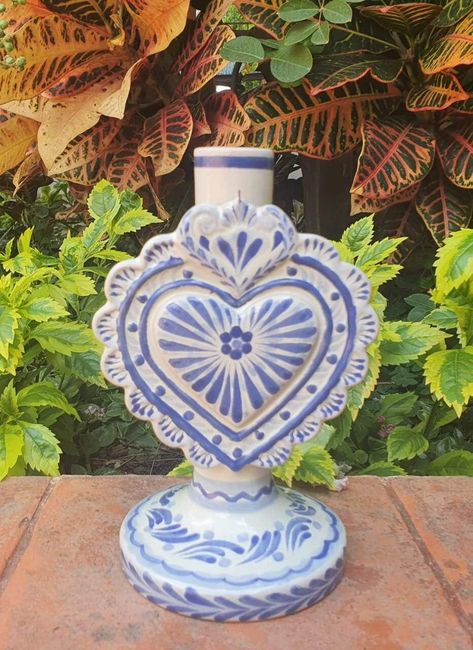 LOVE HEAR CANDLE HOLDER 4.3in W  X 5.1in L  X 7.7in H 11cm A  X 13cm L  X 19.5cm Alt Internationally recognized and Award Winner Gorky Gonzalez and his workshop have dedicated their work to rescue the traditional majolica of Guanajuato, Mexico.   Each piece is carefully handcrafted. Lead Free handcrafts handmade Mexico visit our website to see more pieces https://gorkygonzalez.com/collections/mexican-pottery-saints-collection Mexican Candles, Mexican Pottery Decor, Garden Gate Ideas, Blue Talavera, Talavera Art, Hacienda Decor, Talavera Design, Heart Candle Holder, Mexican Kitchen Decor