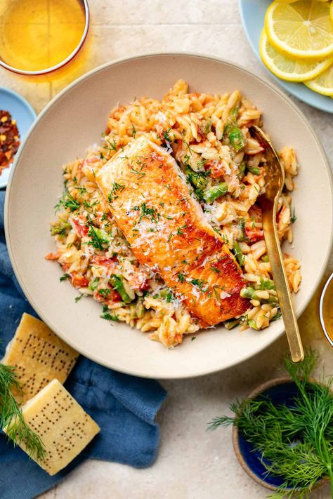 Switch up your standard salmon routine and try out this delicious Creamy Salmon Orzo Skillet! Between the veggies, parmesan cheese, and lemon, it's overflowing with savory flavors. Salmon With Orzo Recipes, Creamy Salmon Orzo, Salmon Orzo Bake, Salmon And Prawn Recipes, Orzo Salmon Recipes, Lemon Orzo Salmon, Salmon And Orzo Recipe, Orzo Salmon, Salmon Orzo Recipe