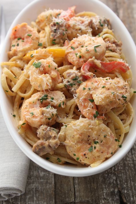 This is a classic Louisiana dish. It is simple to make once you have all of your ingredients prepped. If you want to lighten it up a bit use half and half instead of the heavy cream and go light on the parmesan. Spaghetti Seafood, Emeril Recipes, Emeril Lagasse Recipes, Hungry Monster, Louisiana Dishes, Cream Sauce Pasta, Cooked Shrimp, Italian Sausage Pasta, Creole Cooking