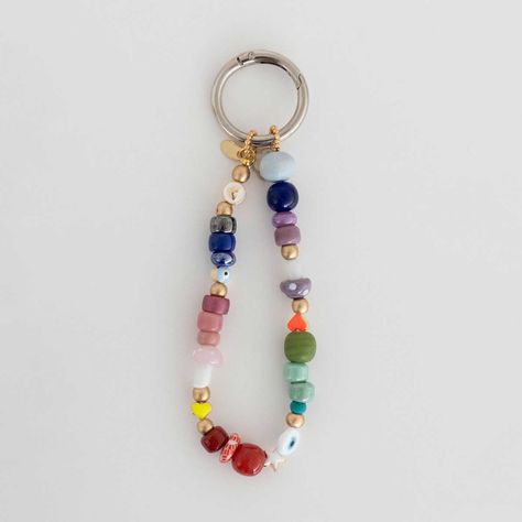 Inspired by traditional Moroccan handicrafts, this charm features intricate patterns and bold colors, making it a standout accessory for any bag. Remember to clip both ends for a rounded charm or just one end for a longer version. You can also use it as a keychain or as a wristlet for your phone for added versatility! Beaded Charms Diy, Beaded Keychain Diy, Diy Beaded Keychain, Bag Charms Diy, Moroccan Handicrafts, Bag Accessories Keychain, Keychain With Beads, Diy Bag Charm, Keychain Beads