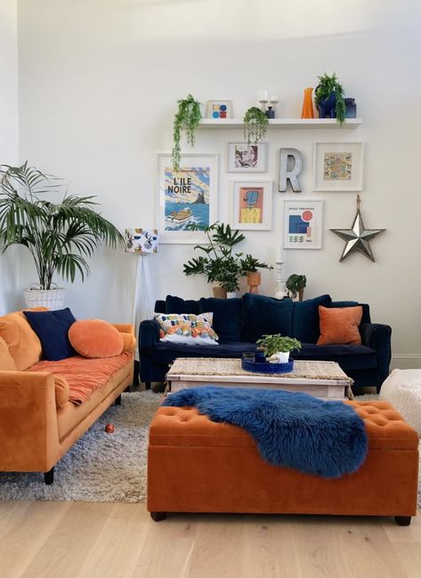 Blue Couch White Walls Living Room, Orange Ottoman Living Room, Blue Couch Orange Rug, Orange And Blue Apartment, Navy And Orange Living Room Decor, Pink Blue Orange Aesthetic Living Room, College Apartment Decor Living Room Blue, Blue And Orange Home Decor, Navy Blue Mustard Yellow Burnt Orange Living Room