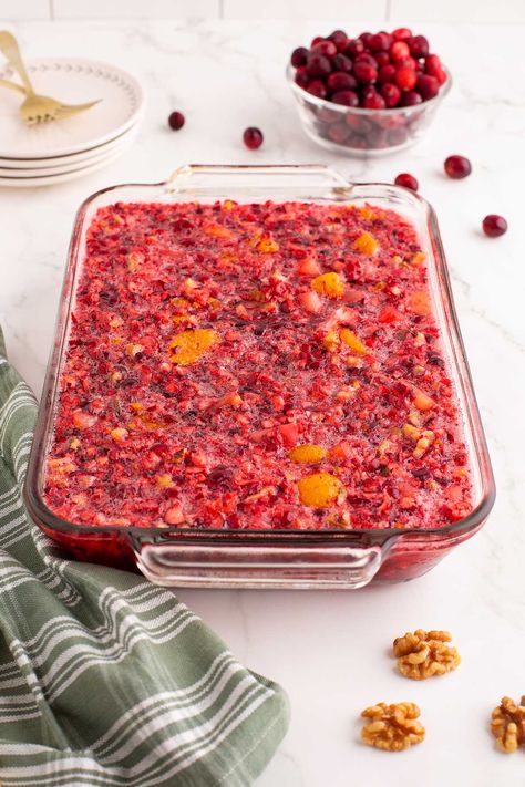 This cranberry jello salad is fantastically fruity. It makes a great jello salad for Thanksgiving dinner or for Christmas dinner (or both!) It's made with juicy fresh cranberries with their sweet tart taste, along with mandarin oranges, pineapple, jello, and more. Although you could serve cranberry orange jello salad as a dessert option, it also makes a nice replacement for canned cranberry sauce, and certainly offers a fresher flavor. This salad is perfect for potlucks and holiday parties. Cranberry Salad Recipes With Jello, Cranberry Pineapple Jello Salad, Thanksgiving Jello Salad, Fresh Cranberry Salad, Holiday Jello, Salad With Pineapple, Orange Jello Salads, Holiday Meal Prep, Cranberry Jello Salad