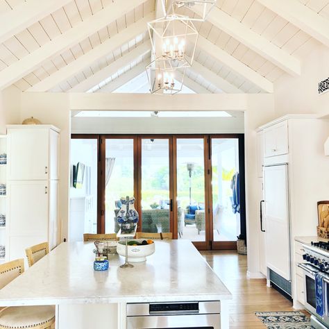 Love our white wide open space kitchen with La Cantina doors  thay open to outside Pool House Gym, Cantina Doors, Deck Doors, Open Space Concept, Open Space Kitchen, White Kitchen Remodel, California Room, Barn Door Ideas, House Gym