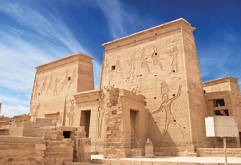 Two monumental pylons form the entryway to the temple of Isis at Philae, which was built by the pharaoh Ptolemy II beginning around 260 B.C. Reliefs on this pylon depict the pharaoh Ptolemy XII smiting his enemies and preparing to sacrifice them to the gods Isis, Horus, and Hathor. Philae Temple, Egyptian Temple, Luxor Temple, Egypt Tours, Visit Egypt, Valley Of The Kings, Egypt Travel, Egyptian Gods, Destin Beach