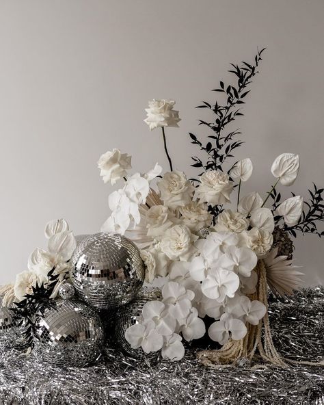 White Flowers And Disco Balls, Disco Ball Wedding Florals, New Years Eve Wedding Florals, Disco Ball Centre Pieces, Black And White Flowers Wedding, Disco Ball Floral Arrangement, Silver Floral Arrangements, Silver Event Decor, Silver Table Decorations