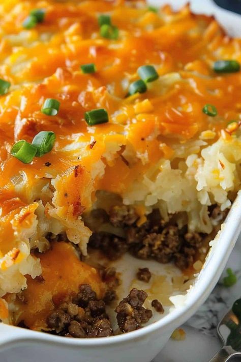 Closeup of half eaten cheesy hash brown casserole in baking dish on white countertop. Hamburger Hash Brown Casserole, Hamburger Hash, Best Chicken Casserole, Million Dollar Chicken, Hamburger Casserole, Creamy Potato Salad, Beef Hash, Hash Brown Casserole, Dinner With Ground Beef