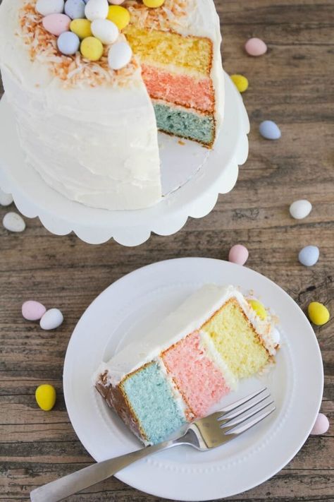 A colorful vanilla cake topped with whipped buttercream and decorated with toasted coconut and mini Cadbury eggs. This Easter egg layered cake is the perfect showstopper for your Easter celebration! #easter #easterrecipes #easterdesserts #cake #cakerecipes #dessert #dessertrecipes #recipes #iheartnaptime Easter Cake Easy, Easter Egg Cake, Easter Cake Recipes, Dessert Parfait, Colorful Desserts, Egg Cake, Slow Cooker Desserts, Family Easter, Easter Baking