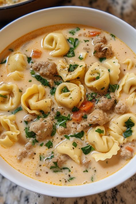 Enjoy the ultimate creamy sausage tortellini soup recipe, a deliciously easy and healthy meal with meat, vegetables, and dairy. Featuring Italian sausage for an authentic taste, it's the best way to warm up. You can prepare tortellini soup in a Crock Pot, instant pot, slow cooker, or stove top. Check out this tortellini soup recipe and more soup recipes at simplycalledfood.com. Ground Beef And Tortellini Soup, Creamy Sausage Tortellini Soup Stovetop, Sausage Tomato Tortellini Soup, One Pot Creamy Sausage Tortellini Soup, Tortellini Hamburger Soup, Cheeseburger Tortellini Soup, Tortellini Soup Easy Quick, Instant Pot Sausage Tortellini Soup, Creamy Beef Tortellini Soup