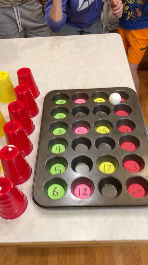 Muffin Tin Match Game 🧁 | prize, entertainment, muffin | Muffin Tin Match Game 🧁 Dad and Family try to bounce ping pong ball into numbered muffin tin for prizes under the corresponding cups. Lots of fun... | By Peter B | Facebook Cupcake Pan Games, Muffin Tin Game Christmas, Cupcake Pan Game, Prize Game Ideas, Christmas Muffin Tin Game, Egg Carton Games, Muffin Tin Game, Cupcake Pan Holiday Game, Ping Pong Prize Game