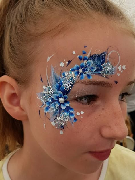 Blue floral eye design Face Painting Eye Designs, Floral Face Painting, Blue Face Paint Ideas, Floral Face Paint, Adult Face Paint, Flower Face Paint, Frozen Face Paint, Eye Face Painting, Face Painting Flowers