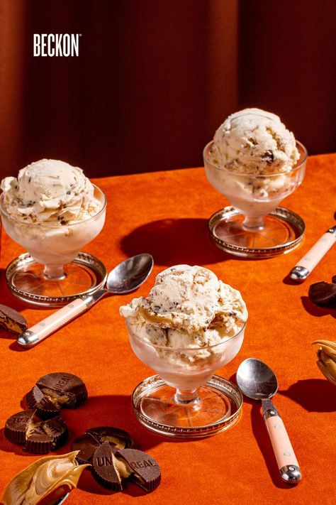 Three clear small goblets laid out in a triangular form each with Beckon Ice Cream's Lactose Free Peanut Butter Cup (upcylced made with UNREAL Snack Peanut Butter Cups). The setting is a retro orange table with pink and silver spoons net to each goblet. On the surface is also broken up peanut butter cups as well as a few extra spoons each with peanut butter scoops on them. Ice Cream Peanut Butter, Lactose Free Desserts, Peanut Butter Cup Ice Cream, Ice Cream Photography, Indulgent Food, Ice Cream Brands, Chocolate Peanut Butter Cups, Healthy Ice Cream, Food Drink Photography