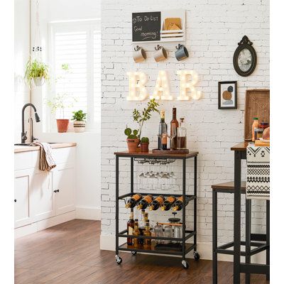 Maximize your space with this compact and stylish bar cart. Its versatile design and durable construction make it perfect for small spaces, while its easy assembly ensures quick setup. Use it as a serving tray or storage solution in any room. 17 Stories Top Color: Brown | 17 Stories Yesli Metal Bar Cart 23.6 W in / grayWood / Steel in Brown | 23.58" W X 15.71" D;23.58" W X 15.71" D | Wayfair Bar Cart Inspo, Bar Mobile, Bar Cart Ideas, Apartment Mood Board, Stemware Rack, Serving Trolley, Bar Cart Styling, Kitchen Trolley, Cart Ideas