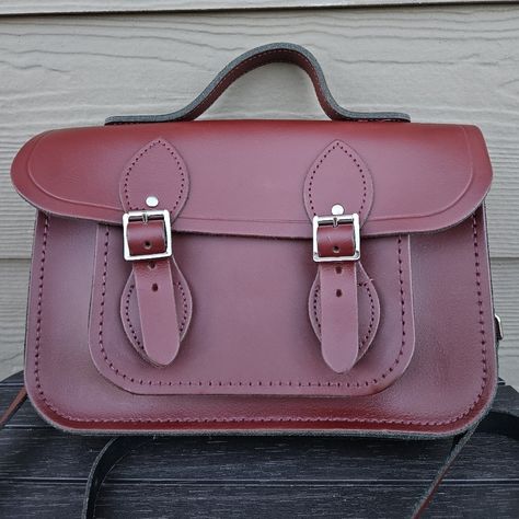 The Cambridge Satchel Company Oxblood Red Crossbody Bag British Leather Purse This Cambridge Satchel Company Crossbody Bag Is Stunningly Gorgeous! Excellent Condition With No Flaws! This Bag Is Out Of Stock Online, But Below Is A Description From Their Website: A Reinterpretation Of The Classic British School Bag, This New Take Pays Homage To The Heritage Of The Bag But Updates The Design By Refining The Dimensions And Adding Convenient Magnetic Closures (Rather Than The Buckle Fastenings Of A T British School, Company Bag, Red Crossbody Bag, Red Crossbody, Oxblood Red, Nickel Hardware, Cambridge Satchel, Cambridge Satchel Company, Satchel Purse