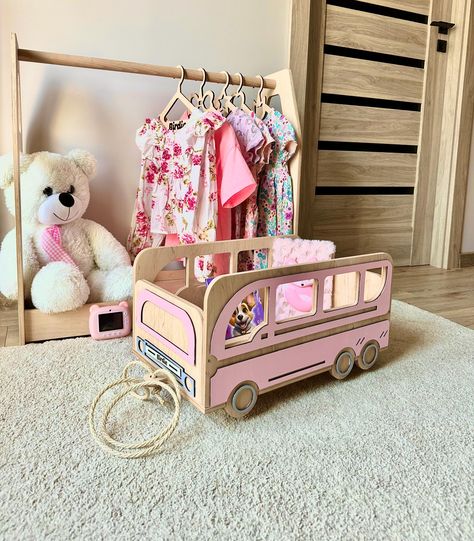 This personalized pink toy cart on wheels is a charming and practical gift idea for a 2-year-old girl, perfect for a niece gift from her aunt. Designed as a rolling toy storage solution, this wooden toy organizer not only keeps toys neatly arranged but also adds a touch of playful elegance to a boho nursery. Shaped like a bus, it combines fun with functionality, making it a delightful addition to any child's room. 🌱DIMENSIONS: Width 11.8 inches (30 cm) Height 11 inches (28 cm) Length 22.8 inches (58 cm) The bus is delivered disassembled. We add assembly and installation instructions to your order Additionally you can get a free gift - personalized name puzzle. Choose the appropriate variation below. 🌱SHIPPING AND IMPORT TAX: We offer fast UPS and FedEx shipping, but be aware of possible Pink Toy, Cart On Wheels, Toy Storage Solutions, Toy Organizer, Niece Gifts, Water Based Acrylic Paint, Name Puzzle, Toy Organization, Boho Nursery