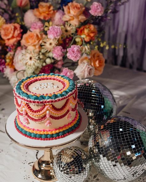 This colourway 👌🏼 @wolfandwildflowerphotography @wolfandthewildflowers_ @rundletailoring @hellofleur_ @confettipartyhire @eventstoadore @emmah.jane.made #vintagevibes #vintagestyle #bespokecake #spodeli #vintagecakesnewcastle #spodelinewcastle #vintagecake #retro #retrocake #vintageweddingcake #lambethcake #heartcake #heartshapedcake #vintageheartcake #roccoco #newcastle #vintageweddingcake #whiteonwhite #renaissance #cakepiping #cakedecorating Retro Themed Cake, Boho Disco Wedding Cake, Eclectic Wedding Cake, Colorful Vintage Cake, Primary Color Cake, Maximalist Cake, Retro Cake Design, 70s Cake, Retro Wedding Cake